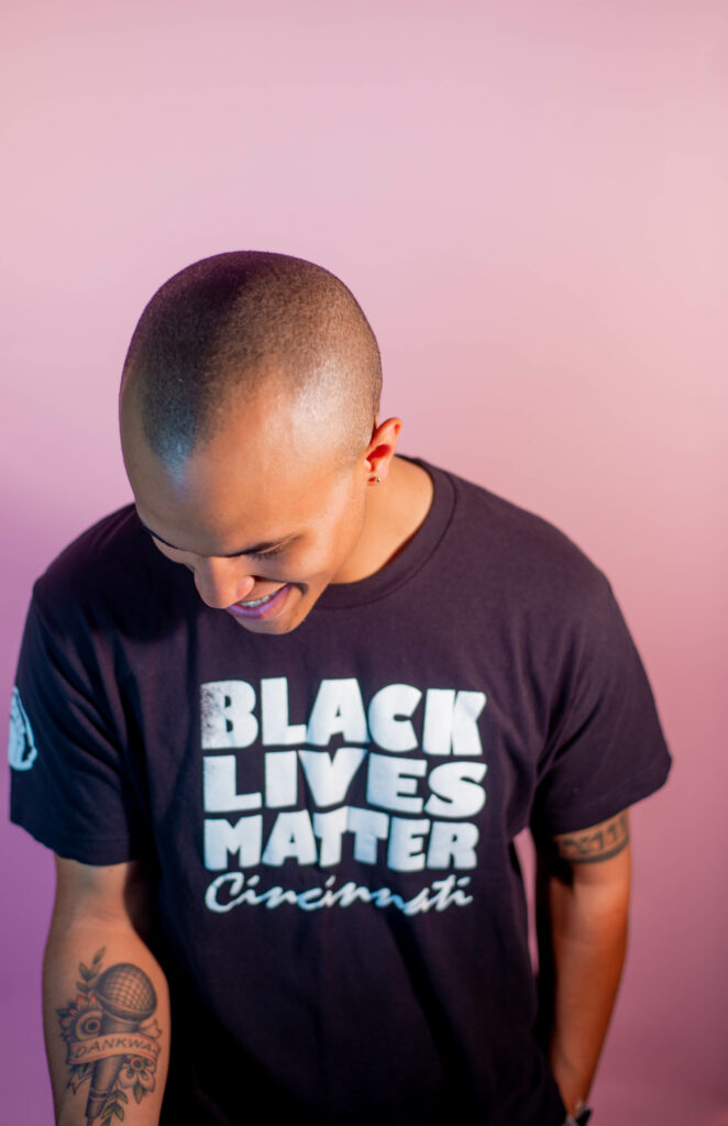 man laughing looking down with black lives matter shirt on