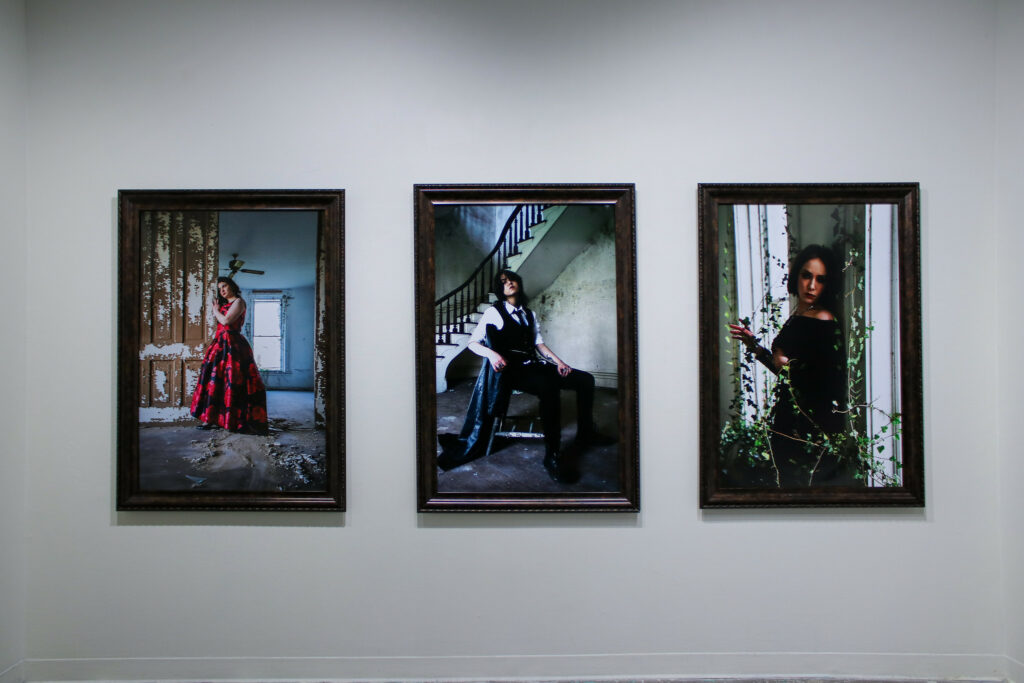 Several photo portraits in a gallery space.