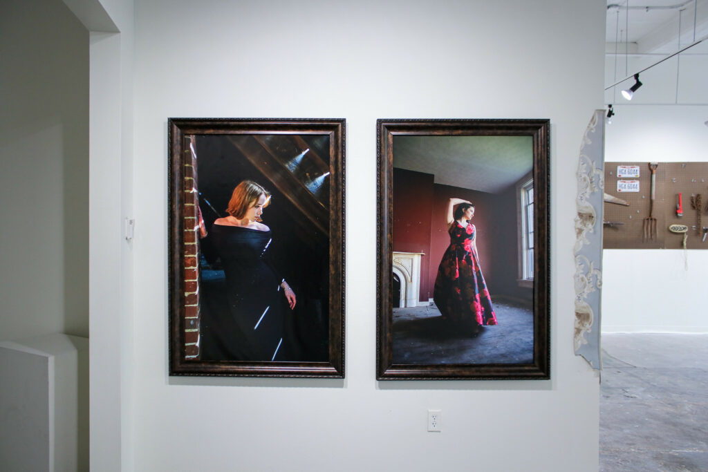 Several photo portraits in a gallery space.