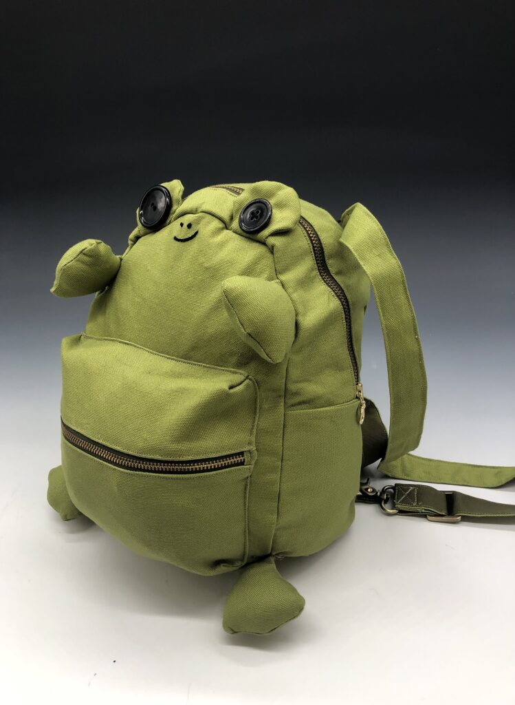 A backpack designed to also look like a frog