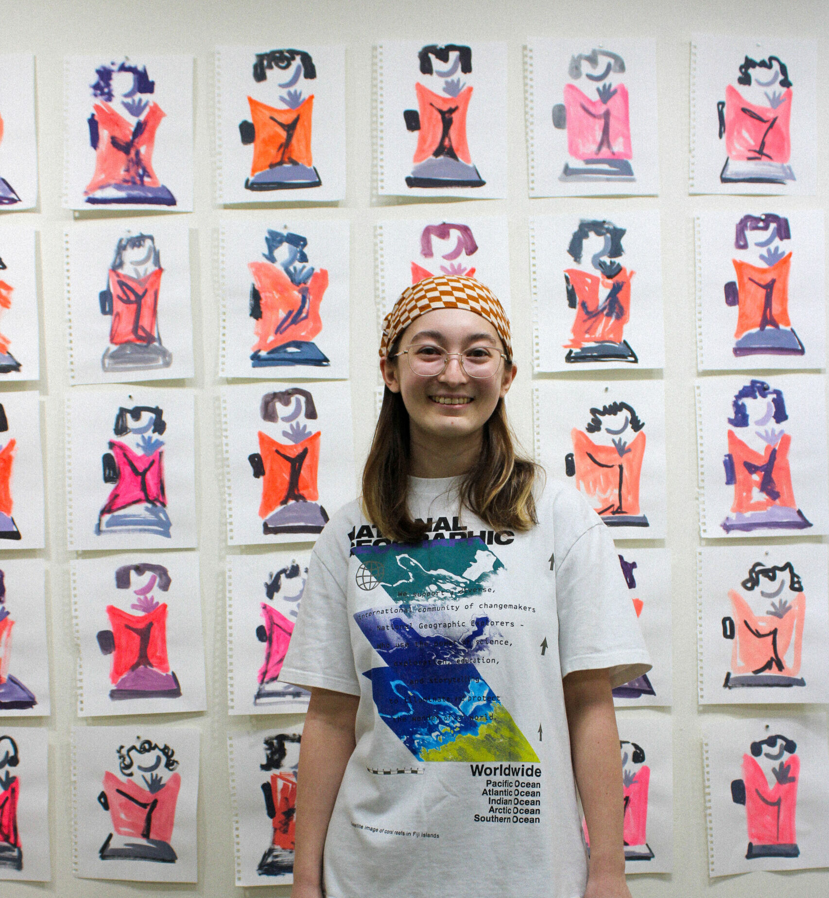 A young artist (Allison Boyle) standing in front of their art