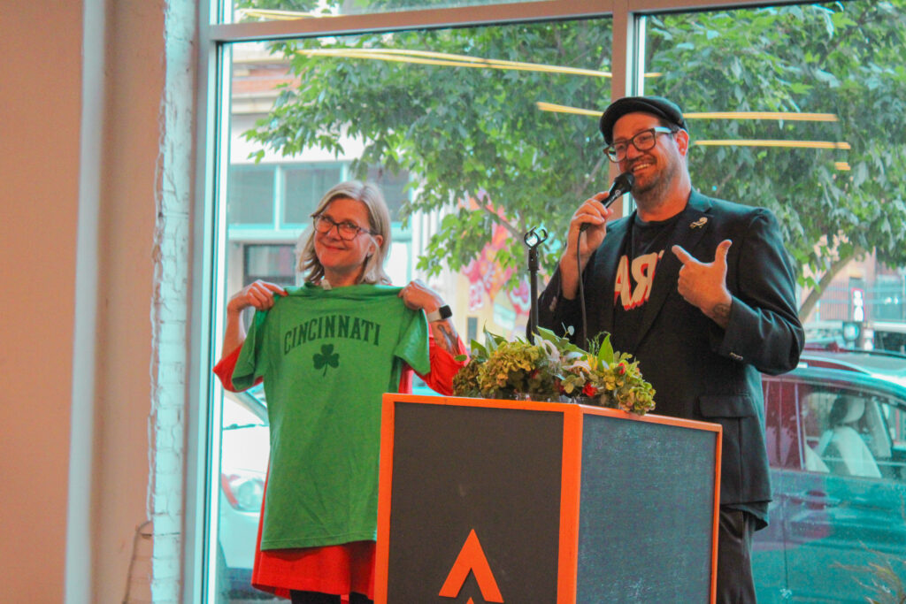 a photo of aac president joe girandola and outgoing aac dean paige williams on stage