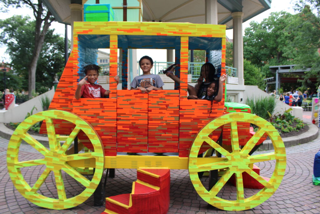 a photo of children in a park in a carriage made entirely of duct tape