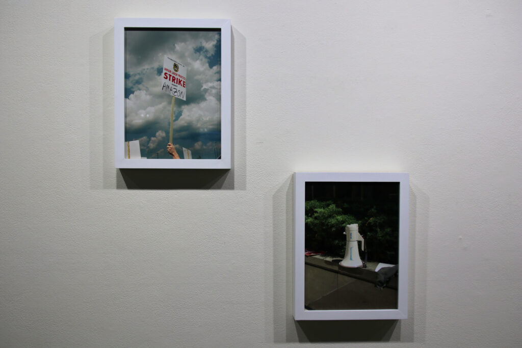 Two photos on a white wall with one photo showing a protest sign and the other photo showing a megaphone